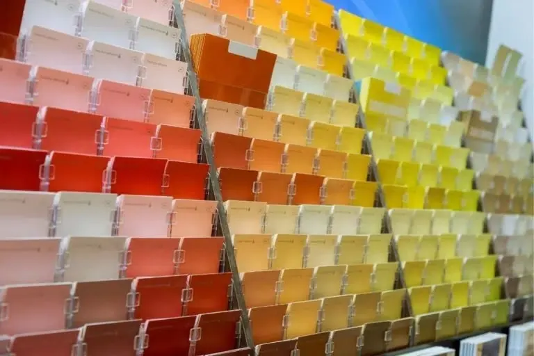 A fanned rack of paint color samples