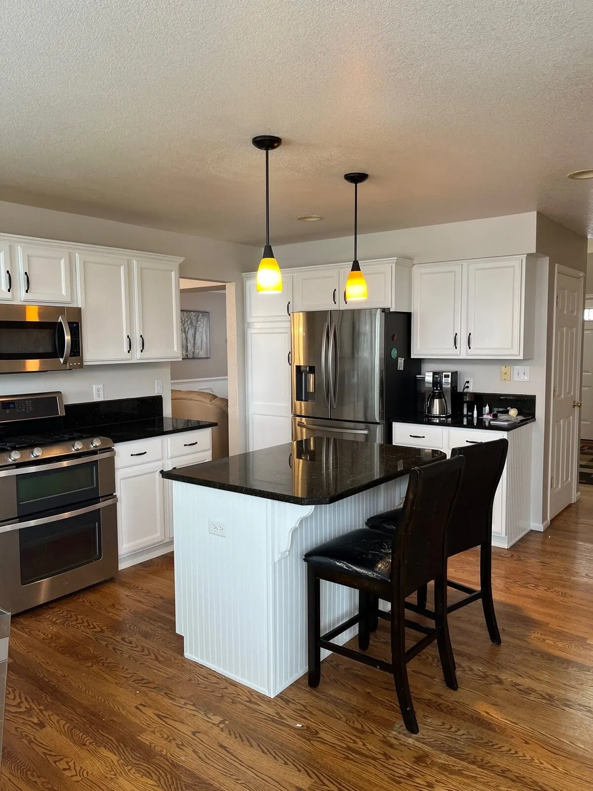 A Denver kitchen with freshly repainted cabinets by Kind Home Painting