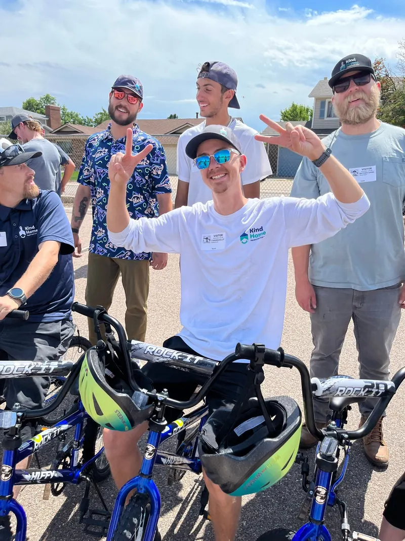 Kind Home Painting team members with a bike built for a Wish For Wheels giveaway